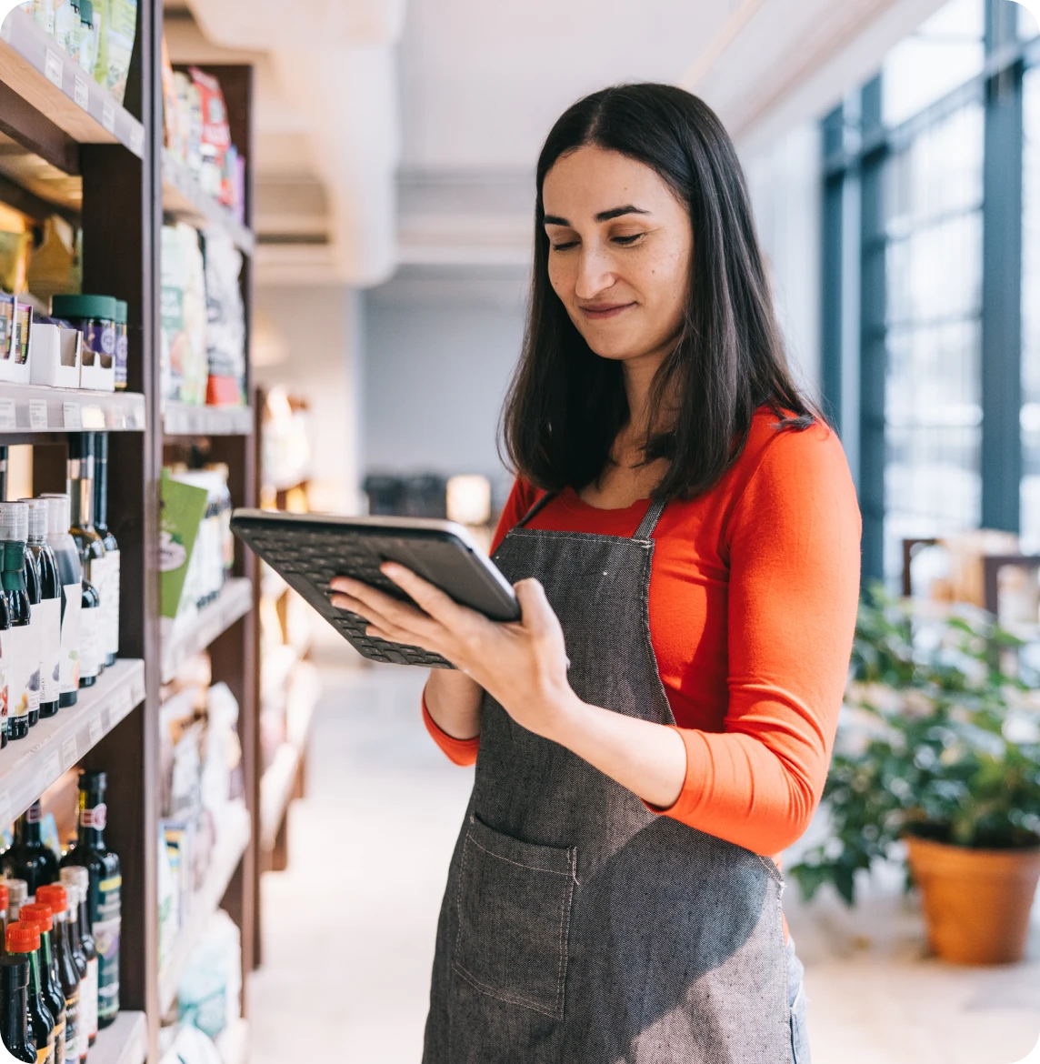 Woman checking inventory on tablet