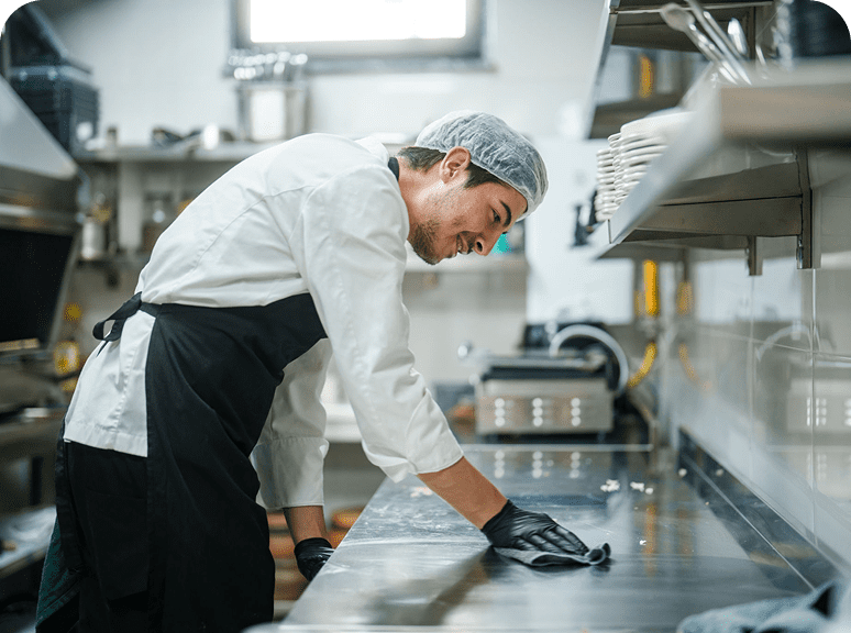 Cook maintaining cleanliness in the kitchen