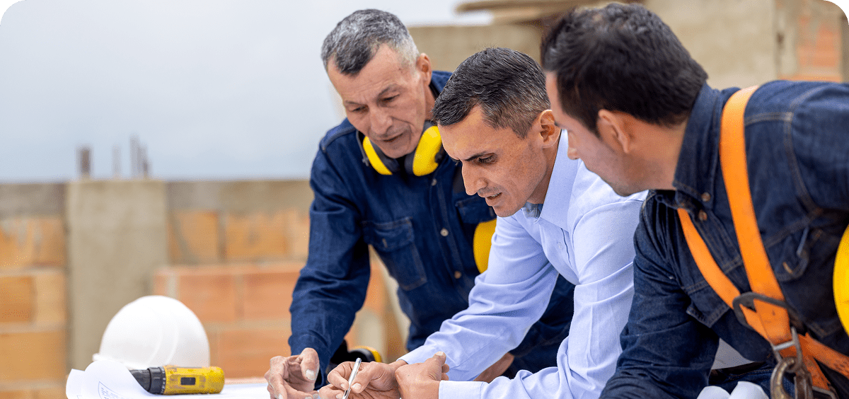 Construction workers reviewing building plans